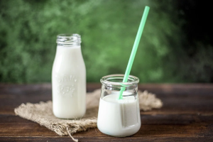 牛乳瓶と牛乳が注がれたストローの入ったコップ