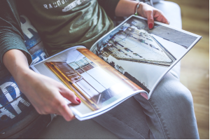 座りながらソファの上で雑誌を開いている