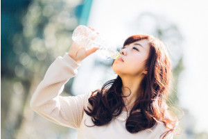 水分補給する髪の長い女性